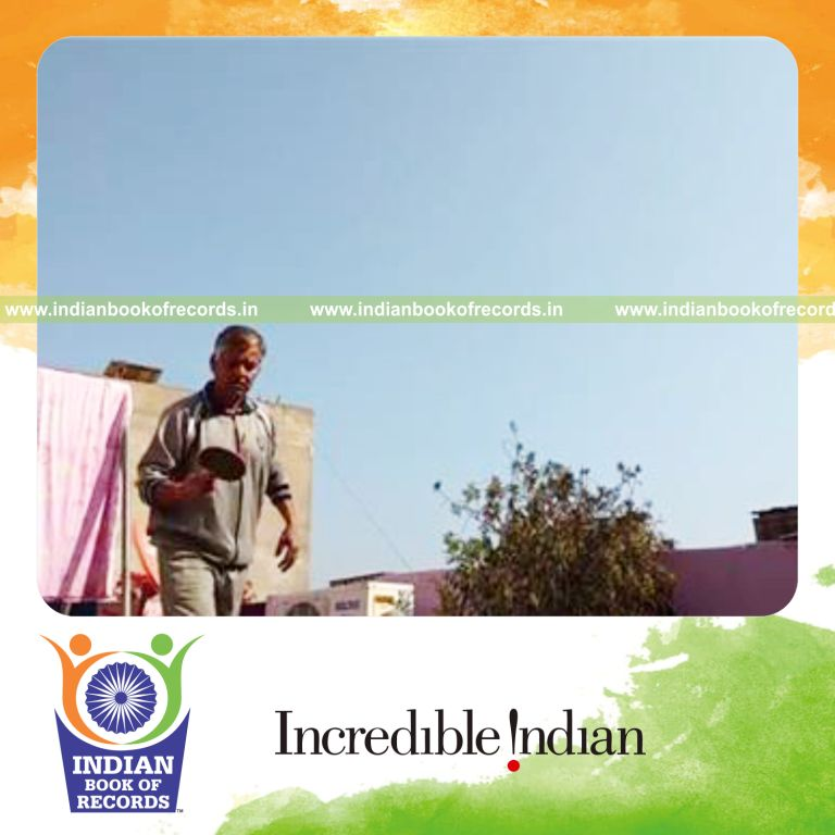 individual bouncing peanut on alternate sides of paddle for record in Indian Book of Records