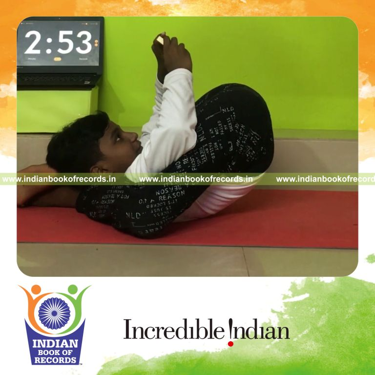individual male solving single digit addition problems using abacus while holding dwi pada sirsasana yoga pose for Indian Book of Records