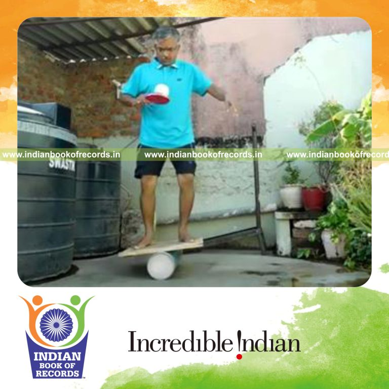 individual bouncing softball on alternate paddle sides while balancing on rola bola for record in Indian Book of Records