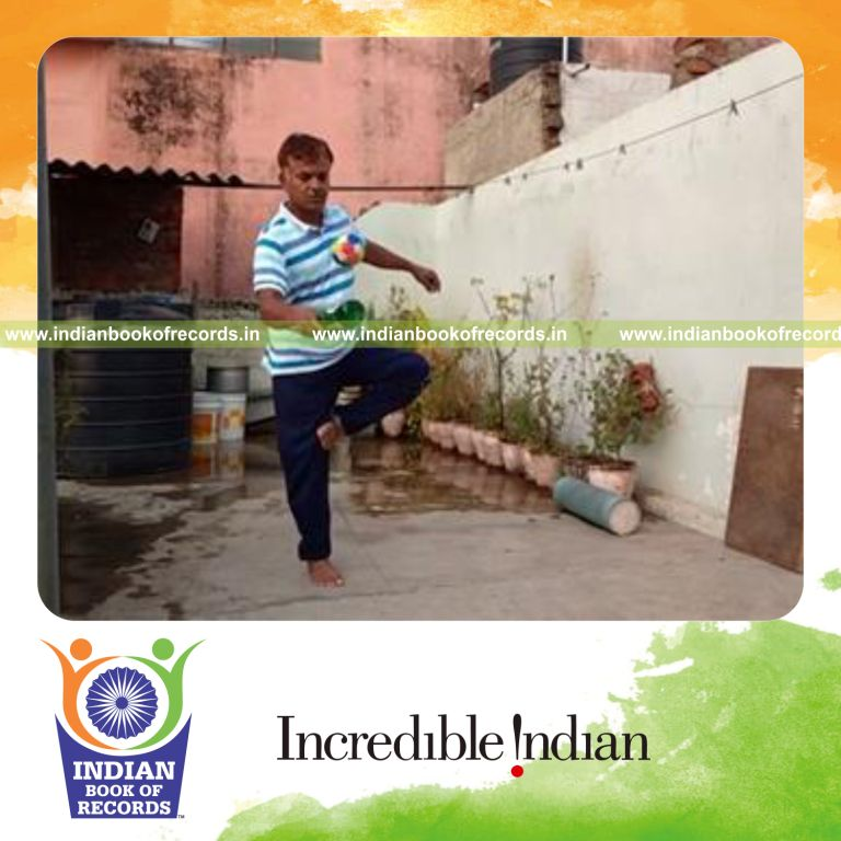 individual bouncing softball on beer bottle while standing on one leg for record in Indian Book of Records