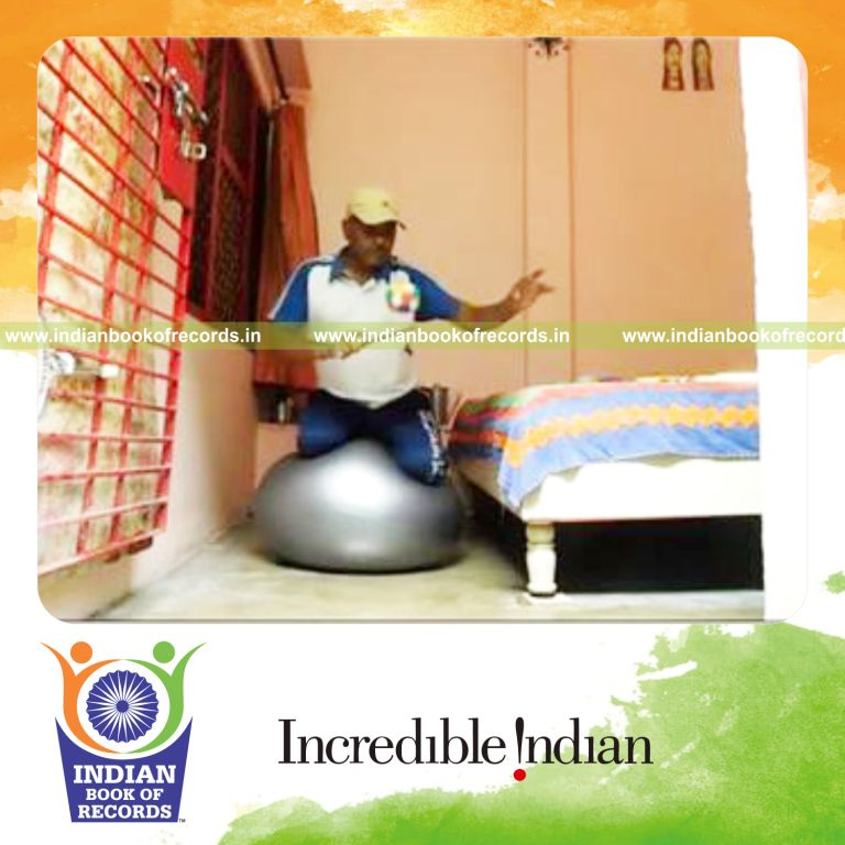 individual bouncing sponge ball on paddle while kneeling on exercise ball in one minute for record in Indian Book of Records