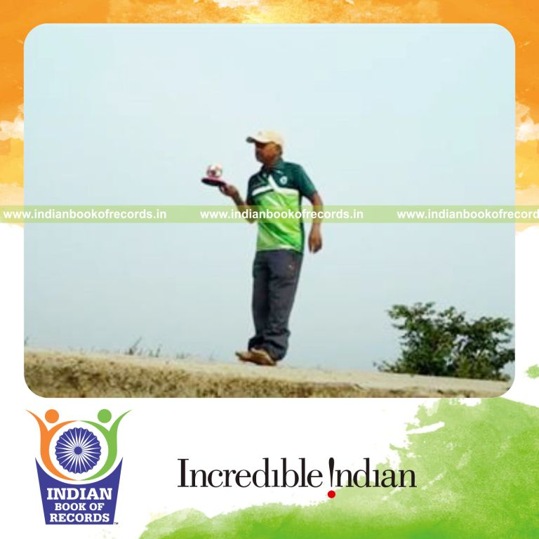 individual bouncing sponge ball on paddle while standing on heels for record in Indian Book of Records