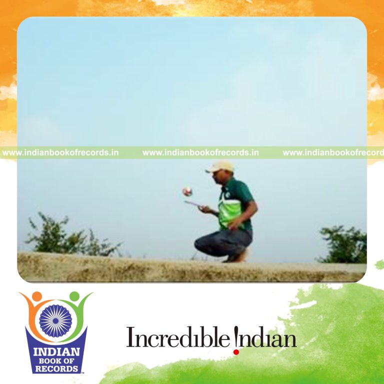 individual bouncing sponge ball on paddle while sitting on toes for record in Indian Book of Records