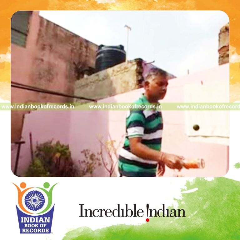 individual bouncing squash ball on beer bottle for record in Indian Book of Records