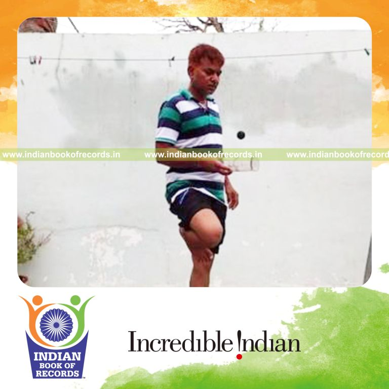 individual bouncing squash ball on wine bottle while standing on one leg for record in Indian Book of Records