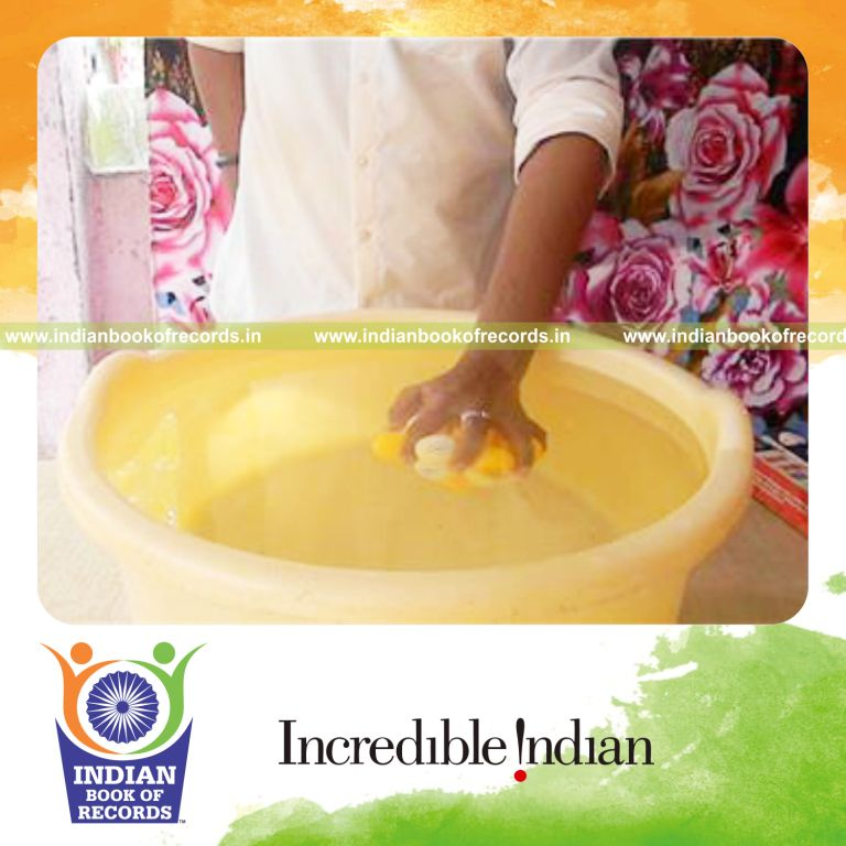 individual holding table tennis balls underwater with one hand for record in Indian Book of Records