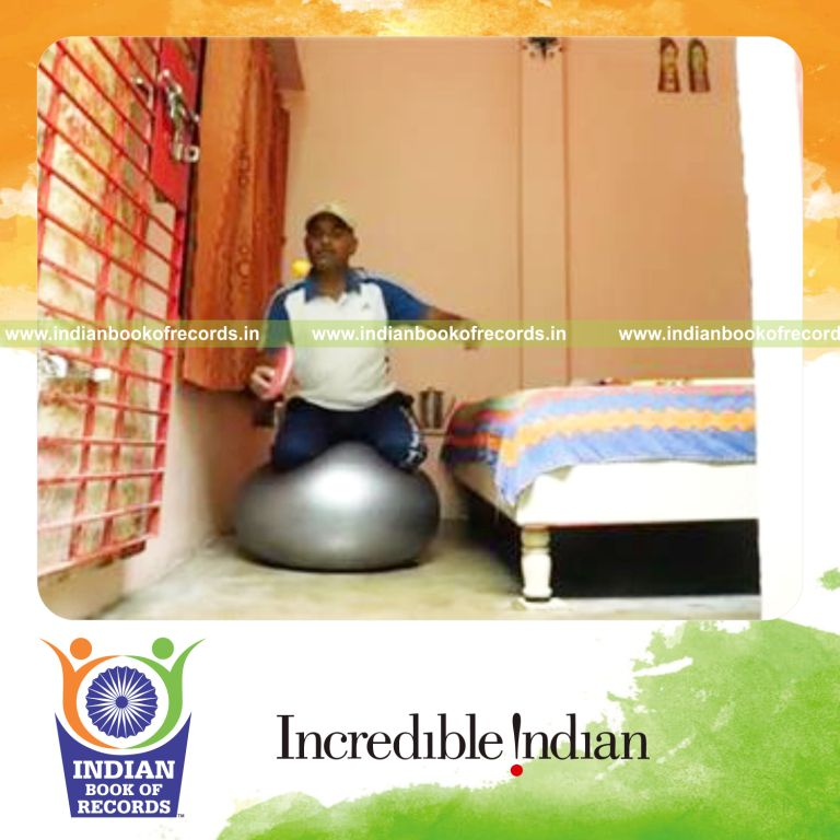individual bouncing table tennis ball on paddle while kneeling on exercise ball for record in Indian Book of Records