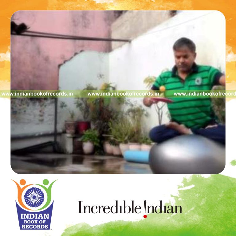 individual bouncing table tennis ball on paddle while holding lotus pose on exercise ball for record in Indian Book of Records
