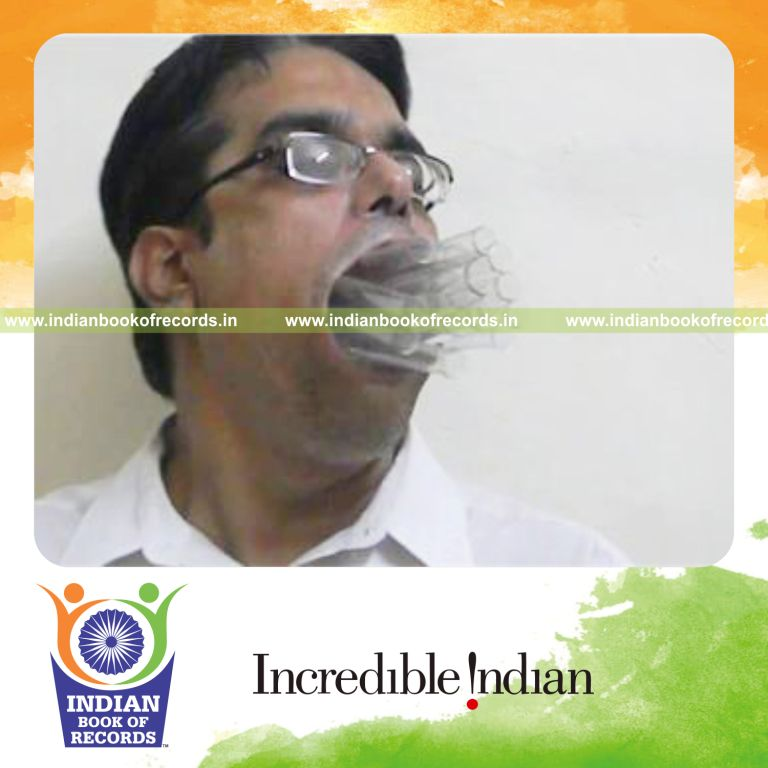 individual fitting maximum number of test tubes in mouth at once for record in Indian Book of Records