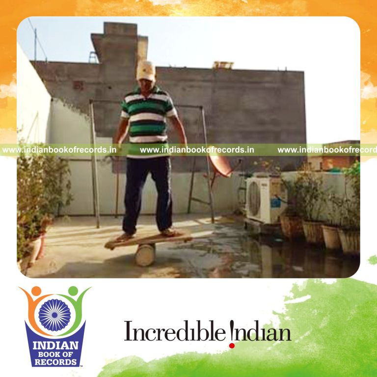 individual bouncing table tennis ball on wine bottle while balancing on rola bola for record in Indian Book of Records