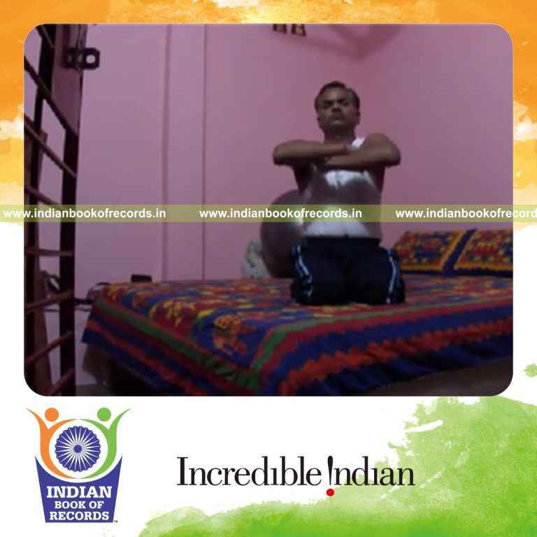 individual folding arms while holding thunderbolt pose for record in Indian Book of Records
