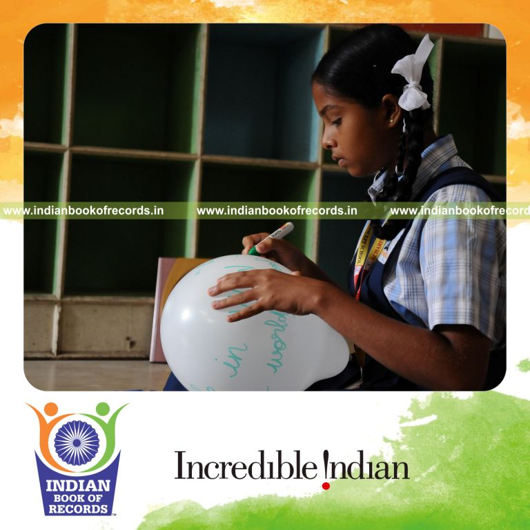 young female blowing balloons and writing captions within six hours for record in Indian Book of Records