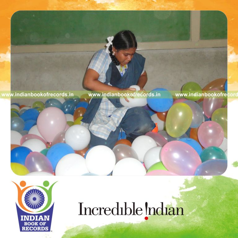 young female bursting balloons within thirty minutes for record in Indian Book of Records