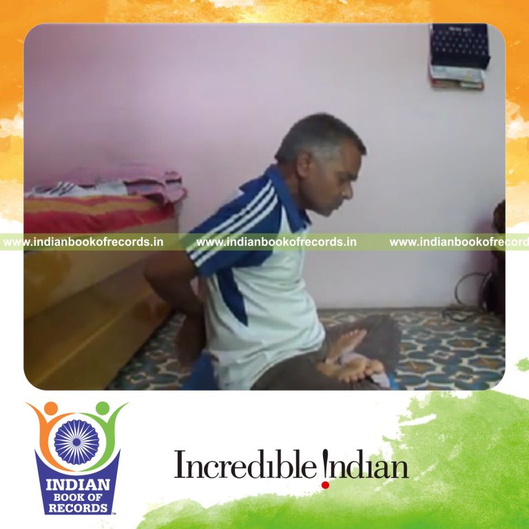 individual performing behind the back claps while holding lotus pose for record in Indian Book of Records