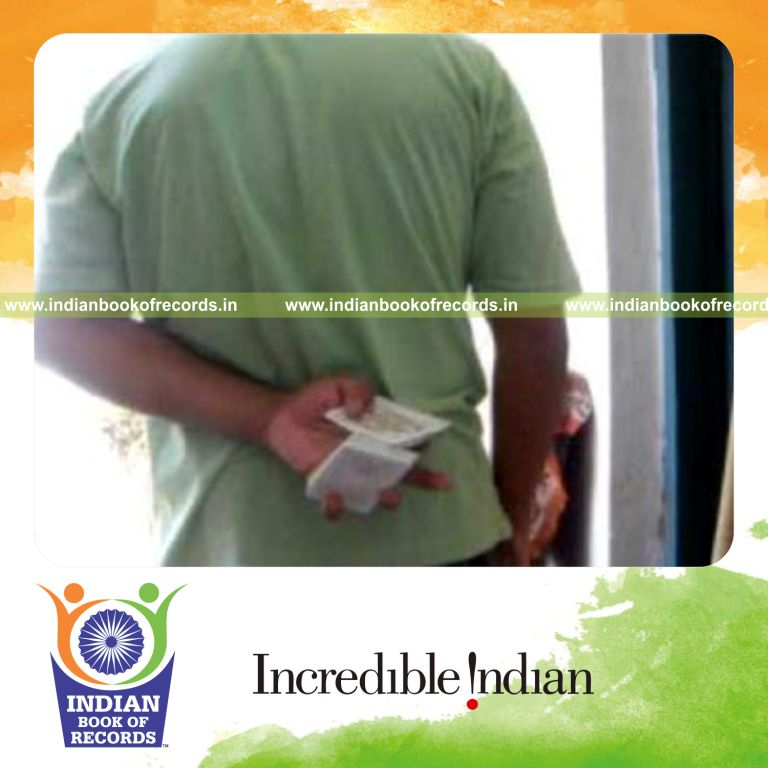 individual performing maximum behind back muse card cuts in 30 seconds for record in Indian Book of Records