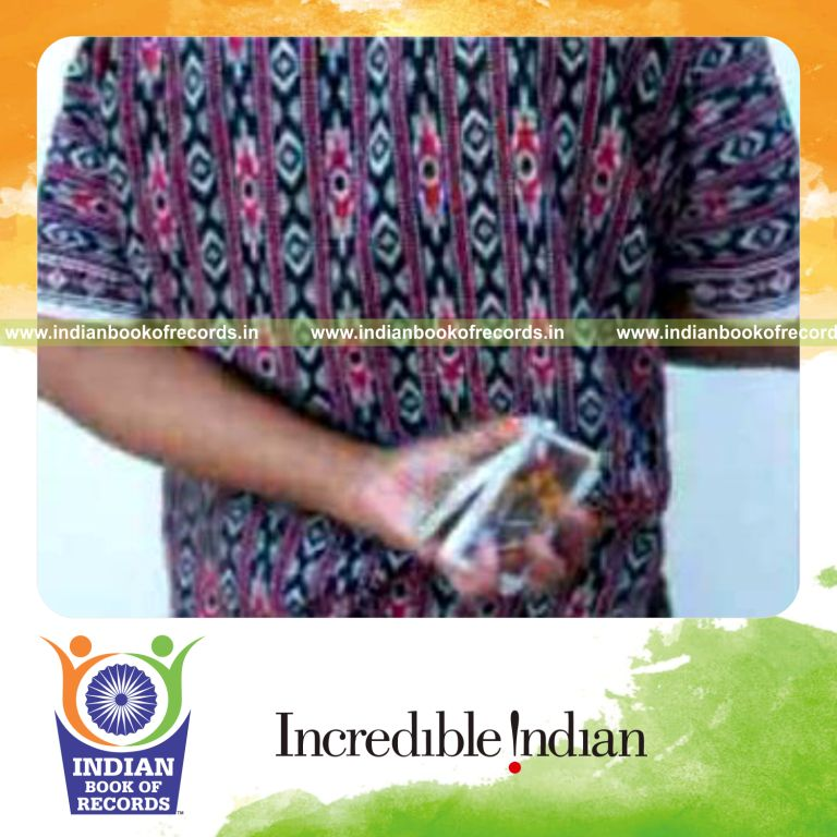 individual performing maximum behind back three packet thumb cuts in one minute for record in Indian Book of Records