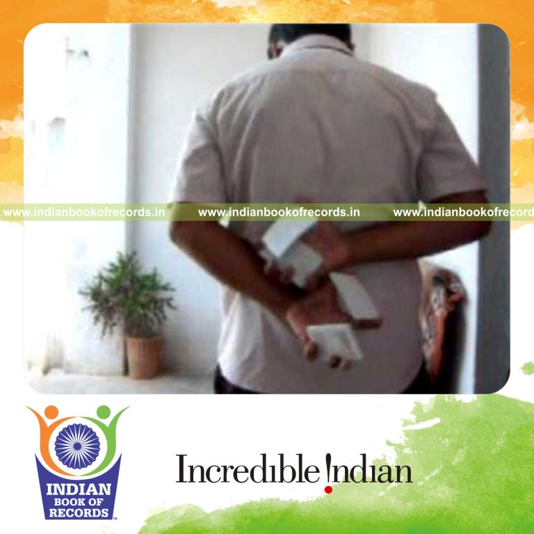 individual performing maximum behind back two handed reverse scissor cuts in 30 seconds for record in Indian Book of Records