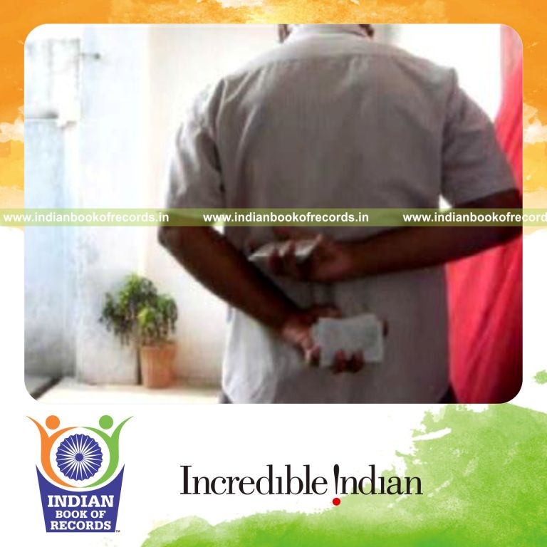 individual performing maximum behind back two handed reverse scissor cuts in one minute for record in Indian Book of Records