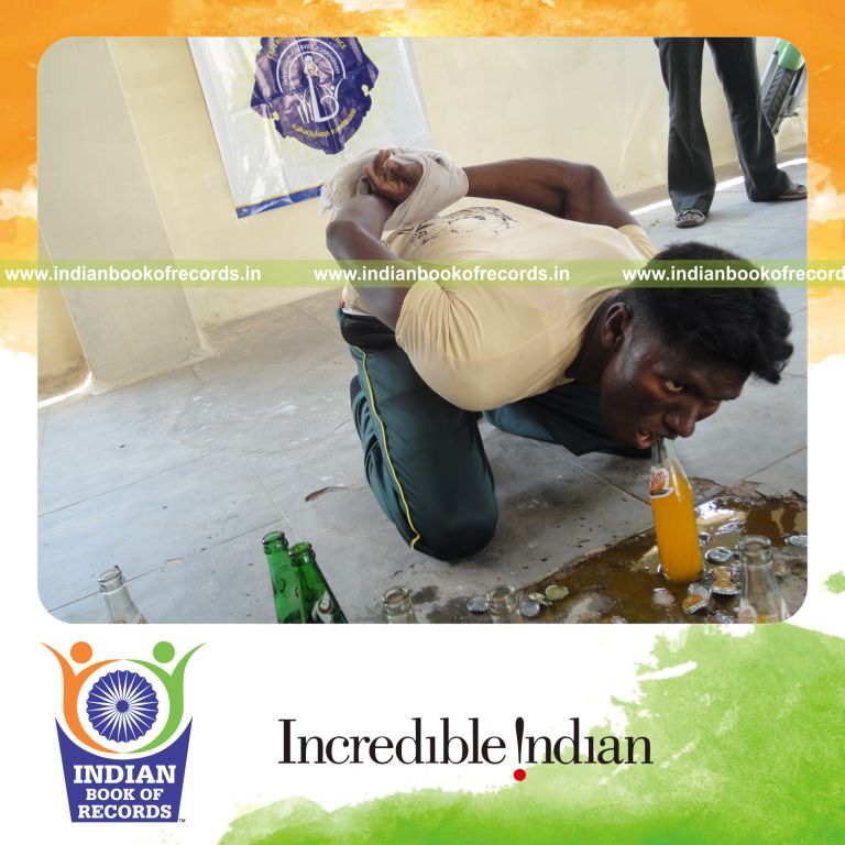 male individual opening bottles using mouth within five minutes for record in Indian Book of Records