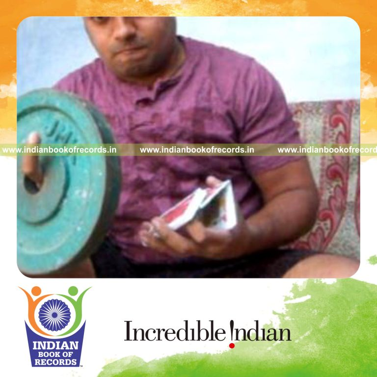 individual performing brian twist card cuts while holding weight plates for record in Indian Book of Records