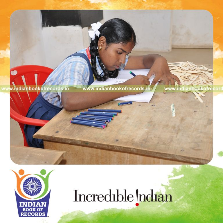 young female writing captions on ice sticks within twelve hours for record in Indian Book of Records