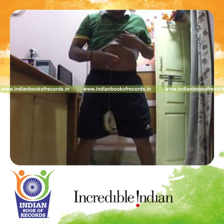 individual balancing cds hanging on strand tied to table tennis ball on navel for record in Indian Book of Records