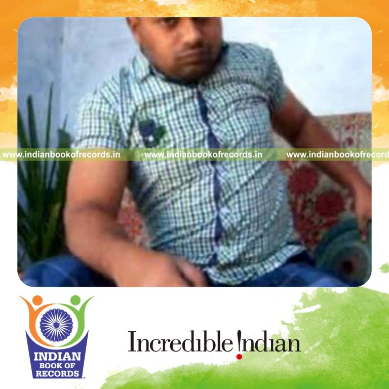 individual performing charlier card cuts while holding heavy weight plate for record in Indian Book of Records