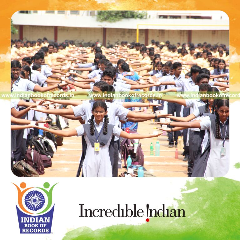 children balancing water filled paper cups in palms for Indian Book of Records