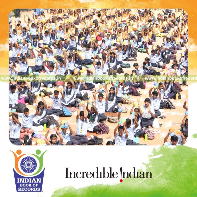 children blowing and bursting balloons simultaneously for an Indian Book of Records