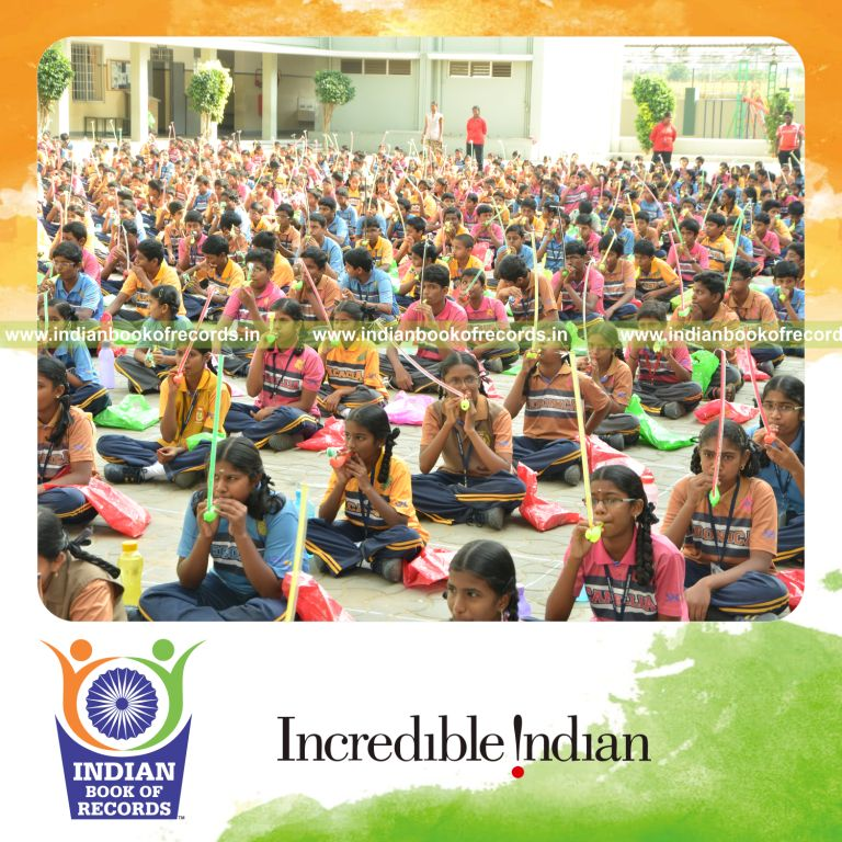 children blowing party whistles together at single venue for Indian Book of Records