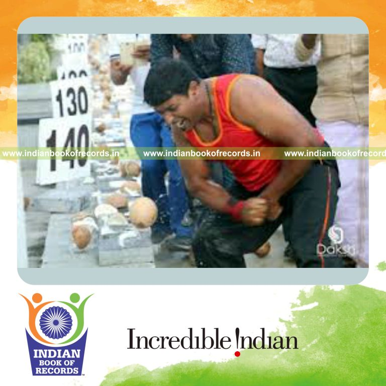 individual breaking coconuts with bare hands in one minute for Indian Book of Records