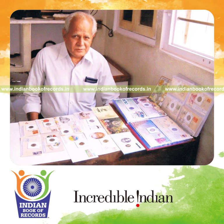 collection of commemorative coins and first day cover stamp pairs displayed for Indian Book of Records
