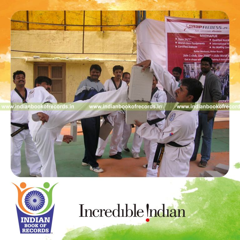 male individual breaking concrete blocks using round house kick within one minute for record in Indian Book of Records