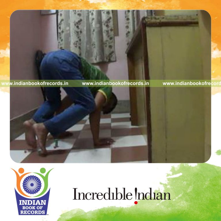 individual stacking dice using feet while holding crow pose for record in Indian Book of Records