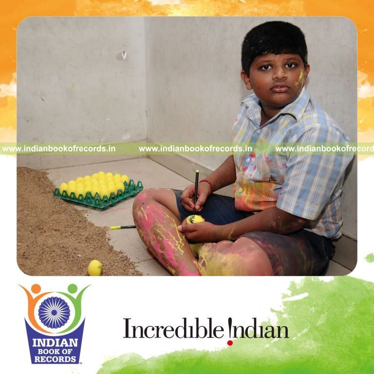 young male painting eggs within six hours for record in Indian Book of Records