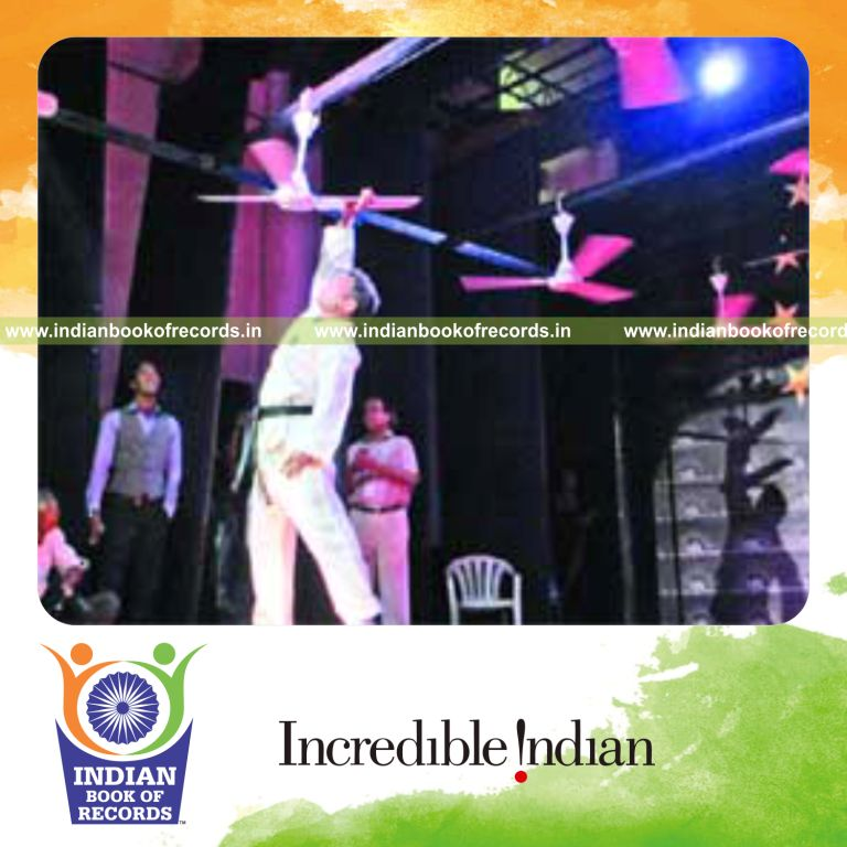 male individual stopping rotating fans with bare hands within one minute for record in Indian Book of Records