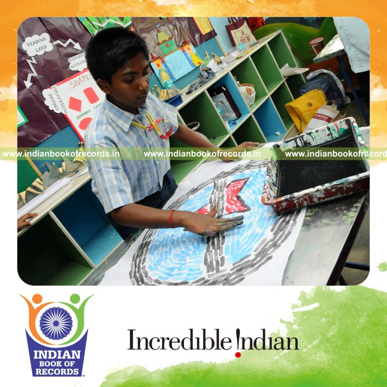 young male creating finger paintings within ten hours for record in Indian Book of Records