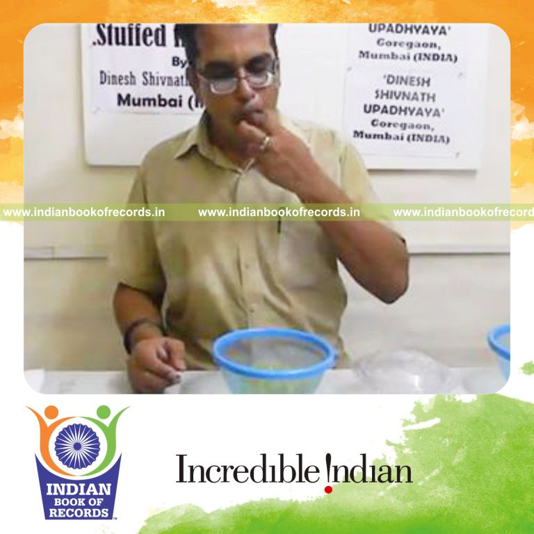 individual fitting grapes in closed mouth for record in Indian Book of Records