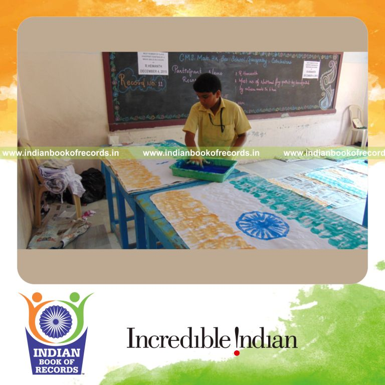 minor male creating handprint painted flags for Indian Book of Records