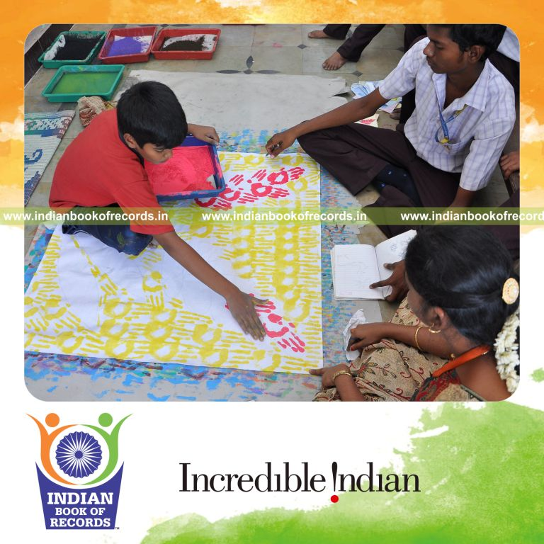 young male creating handprint paintings within ten hours for record in Indian Book of Records