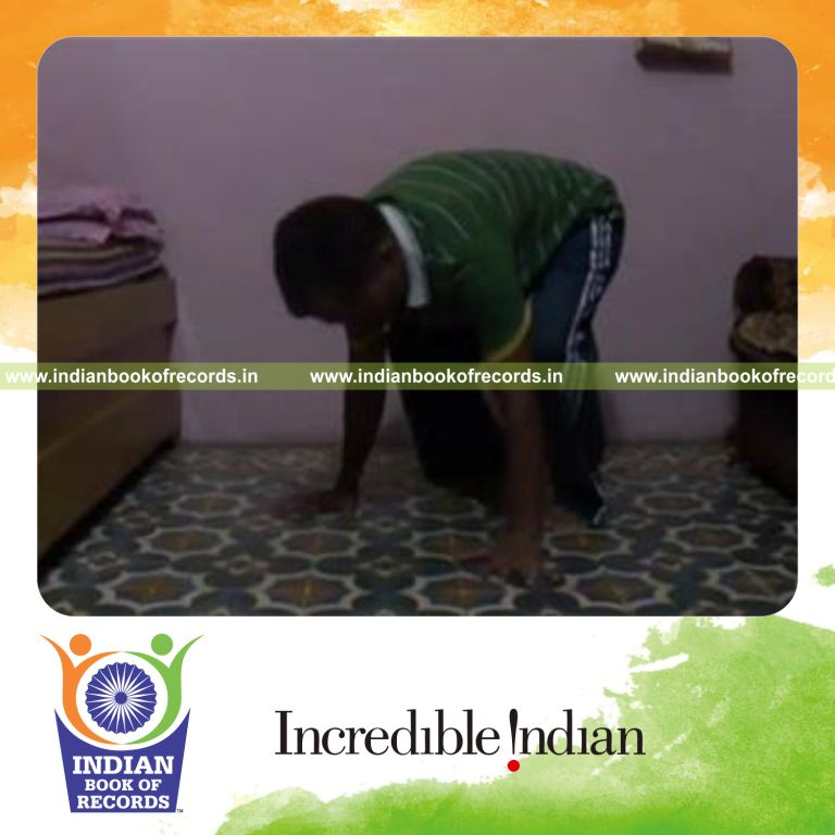 individual performing head rotations while holding crow pose for record in Indian Book of Records