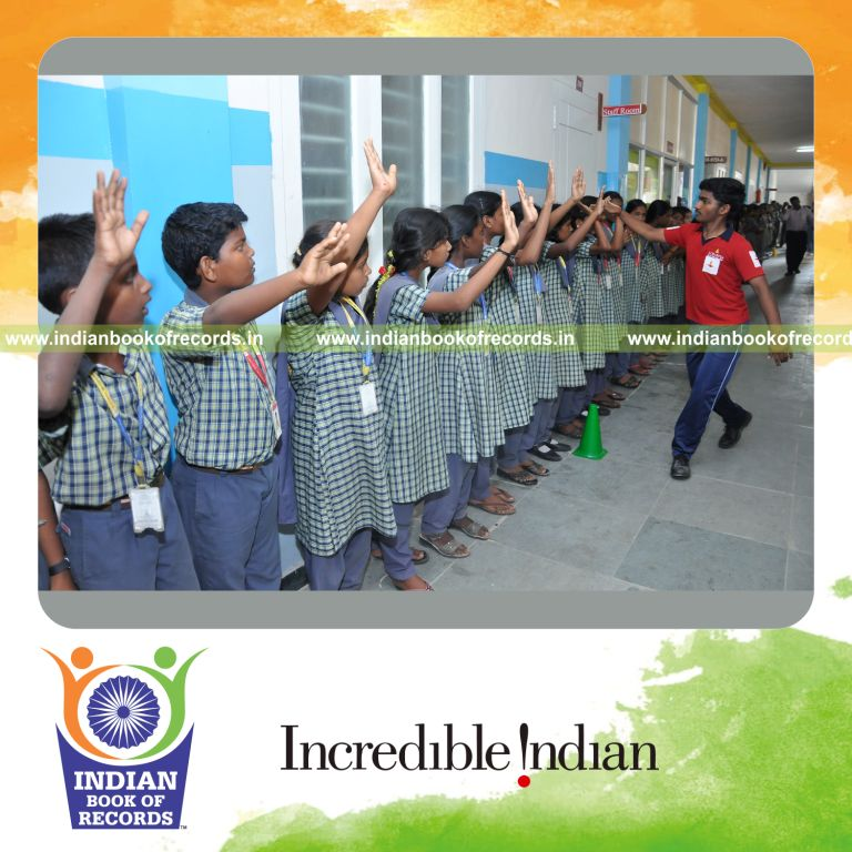 young male doing high fives with multiple people within one hour for record in Indian Book of Records