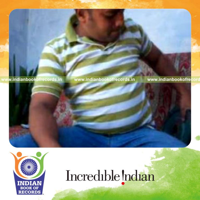 individual performing k town card cuts while holding 20 pound weight plate for record in Indian Book of Records
