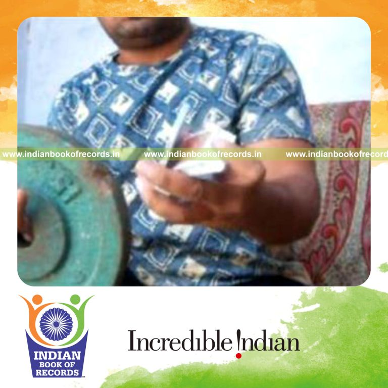 individual performing k town card cuts in one minute while holding weight plate for record in Indian Book of Records