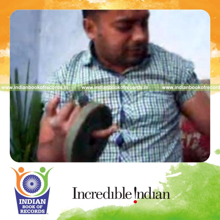 individual performing k town flip card cuts while holding weight plates for record in Indian Book of Records
