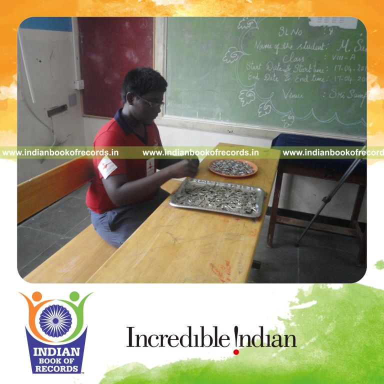 young male putting keys on rings within one hour for record in Indian Book of Records