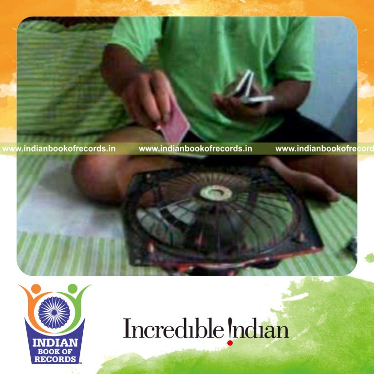 individual performing maximum kryptonite cuts while spinning card with fan for record in Indian Book of Records