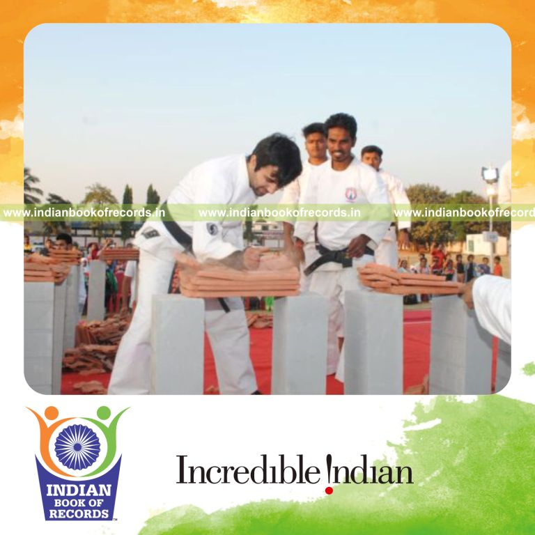 an individual breaking the highest number of mangalore roof tiles in one minute using hammer fist technique for a record in Indian Book of Records