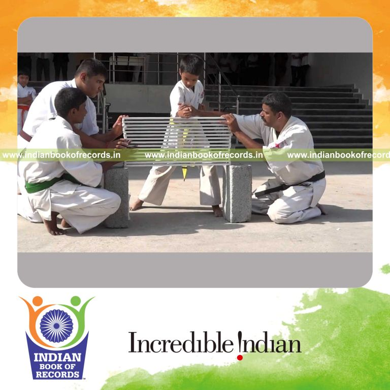 young male breaking multiple marbles with elbow in a single strike for Indian Book of Records