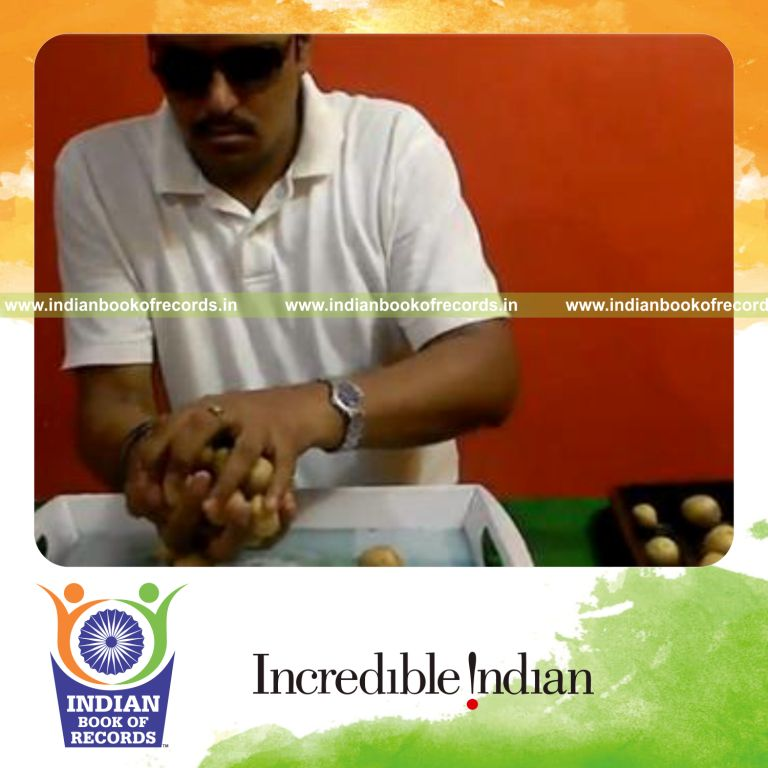 individual holding maximum mini potatoes in hand at once for record in Indian Book of Records